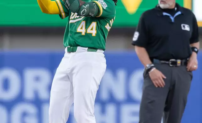 Athletics' Joshua Kuroda-Grauer celebrates after hitting a double during the fourth inning of a baseball game against the Los Angeles Dodgers Wednesday, July 1, 2026, in West Sacramento, Calif. (AP Photo/Sara Nevis)