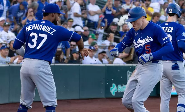 Los Angeles Dodgers' Freddie Freeman (5) celebrates with Teoscar Hernández (37) after hitting a home run during the third inning of a baseball game against the Athletics Wednesday, July 1, 2026, in West Sacramento, Calif. (AP Photo/Sara Nevis)