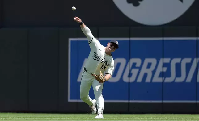 Minnesota Twins right fielder Alan Roden (18) throws the ball to hold Los Angeles Angels' Zach Neto at third base during the third inning of a baseball game Saturday, July 11, 2026, in Minneapolis. (AP Photo/Bailey Hillesheim)