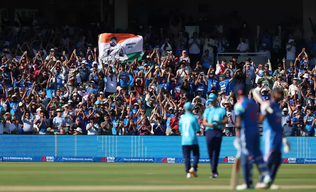 India fans celebrate in the stands after Rohit Sharma reaches his century during the third ODI between England and India, at Lord's cricket ground, London, Sunday, July 19, 2026. (Steven Paston/PA via AP)