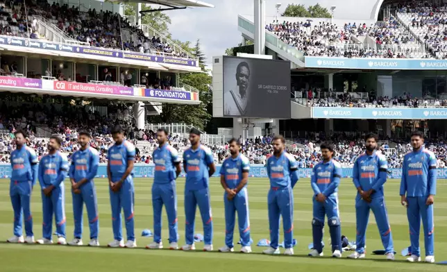 India players stand for a minute of silence in tribute to late cricketer Garfield Sobers at the start of the third ODI between England and India, at Lord's cricket ground, London, Sunday, July 19, 2026. (Steven Paston/PA via AP)