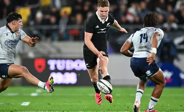 New Zealand's Jordie Barrett kicks the ball past defenders during the Nations Championship rugby international between the All Blacks and Italy in Wellington, New Zealand, Saturday, July 11, 2026. (Kerry Marshall/Photosport via AP)