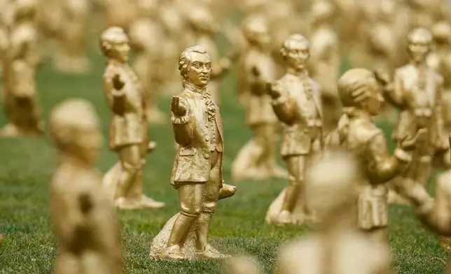 400 gold colored plastic Mozart sculptures by German artist Ottmar Hoerl from Nuremberg stand for the 270th birthday of composer Wolfgang Amadeus Mozart in Salzburg, Austria, Wednesday, July 15, 2026. (AP Photo/Matthias Schrader)