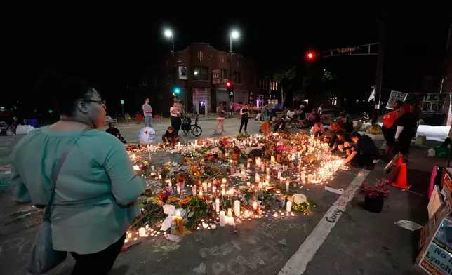 Attendees gather at a memorial Thursday, July 23, 2026, in Madison, Wis., where a Madison police officer shot and killed Corey Durell Ruiz on Wednesday. (AP Photo/Kayla Wolf)