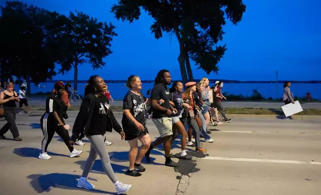 Protesters march Thursday, July 23, 2026, in Madison, Wis., after a Madison police officer shot and killed Corey Durell Ruiz on Wednesday. (AP Photo/Kayla Wolf)