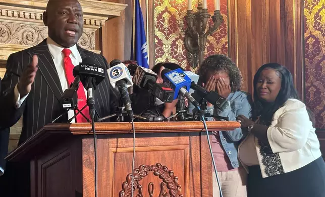 Attorney Ben Crump speaks at a news conference about Corey Ruiz, who was killed by Madison police, while his sister, Veronica Ruiz, breaks down in tears and is comforted by Wisconsin state Rep. Shelia Stubbs, D-Madison, right, Friday, July 24, 2026, in Madison, Wis. (AP Photo/Scott Bauer)