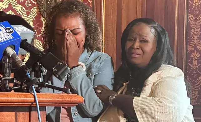 Veronica Ruiz, the sister of Corey Ruiz, who was killed by Madison police, breaks down in tears and is comforted by Wisconsin state Rep. Shelia Stubbs, D-Madison, right, Friday, July 24, 2026, in Madison, Wis. (AP Photo/Scott Bauer)