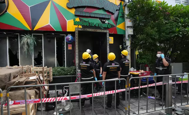 Forensic police officers inspect the site of a fire in Bangkok, Thailand, Monday, July 13, 2026. (AP Photo/Sakchai Lalit)