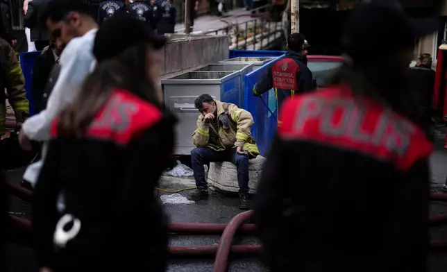 FILE - Firefighters and emergency teams work in the aftermath of a fire that broke out during day time in a nightclub in Istanbul, Turkey, on April 2, 2024. (AP Photo/Khalil Hamra, File)