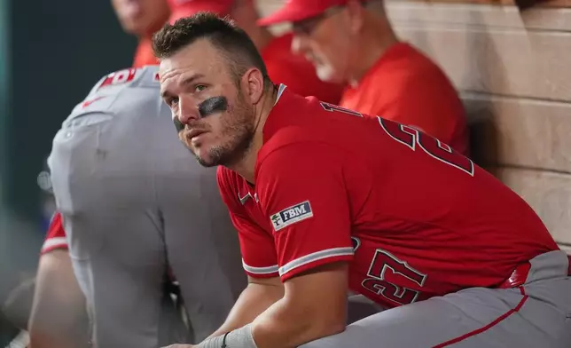 Los Angeles Angels designated hitter Mike Trout looks on from the dugout during the ninth inning of a baseball game against the Texas Rangers, Wednesday, July 8, 2026, in Arlington, Texas. (AP Photo/Julio Cortez)