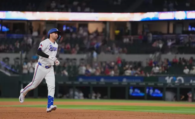 Texas Rangers pinch hitter Kyle Higashioka runs the bases after hitting a solo home run against the Los Angeles Angels during the eighth inning of a baseball game, Wednesday, July 8, 2026, in Arlington, Texas. (AP Photo/Julio Cortez)