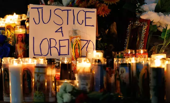 Candles are lit during a vigil for Lorenzo Salgado Araujo, a Mexican national fatally shot by a federal immigration agent a day prior, Wednesday, July 8, 2026, in Houston. (AP Photo/Mark Felix)