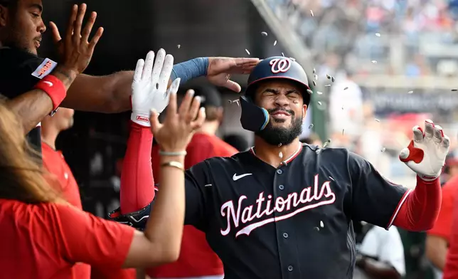 Washington Nationals' Luis García Jr. is greeted in the dugout after hitting a solo home run during the first inning of a baseball gamea gainst the Pittsburgh Pirates, Friday, July 3, 2026, in Washington. (AP Photo/John McDonnell)