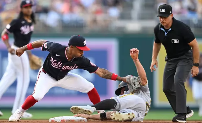 Washington Nationals second baseman Nasim Nuñez, front left, is late with the tag as Pittsburgh Pirates' Jake Mangum, second from right, steals second during the second inning of a baseball game, Friday, July 3, 2026, in Washington. (AP Photo/John McDonnell)