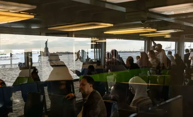 People look at the Statue of Liberty from the Staten Island Ferry, Sunday, May 31, 2026, in New York. (AP Photo/Yuki Iwamura)