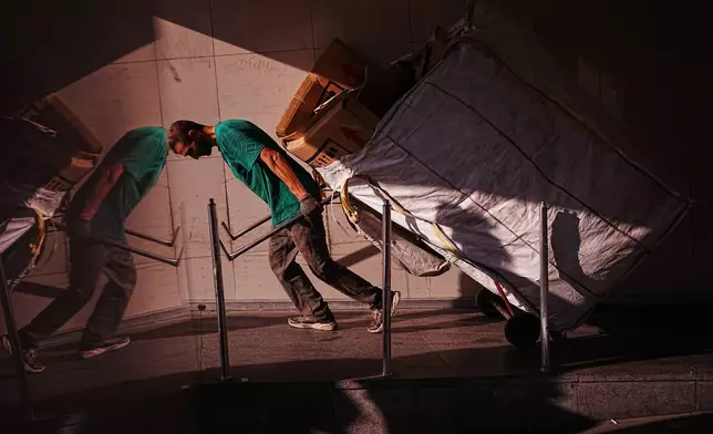 A garbage collector pulls his cart along an underpass at Galata bridge in Istanbul, Turkey, Friday, June 26, 2026. (AP Photo/Francisco Seco)