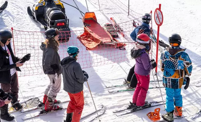 A group of skiers gather on the slopes at Afriski Mountain Resort in Maluti, Lesotho, Saturday, July 11, 2026. (AP Photo/Kayleen Morgan)