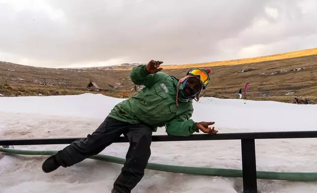 A worker poses near the slopes at Afriski Mountain Resort in Maluti, Lesotho, Saturday, July 11, 2026. (AP Photo/Kayleen Morgan)