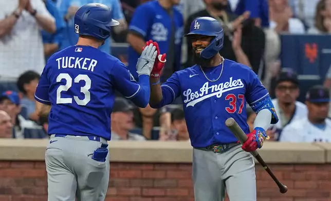 Los Angeles Dodgers' Teoscar Hernández (37) celebrates with teammate Kyle Tucker (23) after Tucker hit a home run during the third inning of a baseball game against the New York Mets Saturday, July 25, 2026, in New York. (AP Photo/Frank Franklin II)