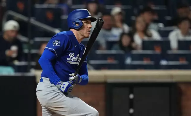 Los Angeles Dodgers' Freddie Freeman hits a single during the seventh inning of a baseball game against the New York Mets Saturday, July 25, 2026, in New York. (AP Photo/Frank Franklin II)