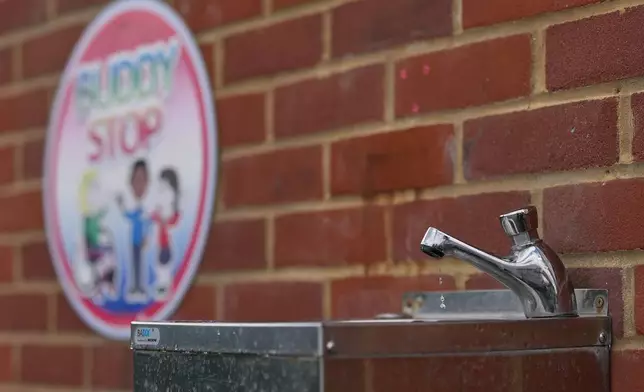 A water fountain is seen in the school yard at Beaconsfield Primary School London, Wednesday, July 1, 2026. (AP Photo/Alastair Grant)