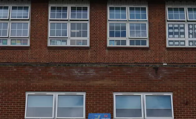 A map of Great Britain on the all next to open classroom window at Beaconsfield Primary School in London, Wednesday, July 1, 2026. (AP Photo/Alastair Grant)