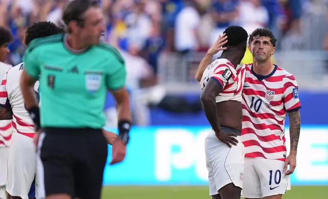 United States' Folarin Balogun, center, gets a hug from United States' Christian Pulisic (10) after being issued a red card by Referee Raphael Claus, of Brazil, during the World Cup round of 32 soccer match between the United States and Bosnia in Santa Clara, Calif., near San Francisco, Wednesday, July 1, 2026. (AP Photo/Martin Meissner)