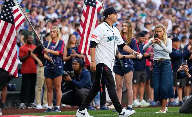 United States men's national soccer team head coach Mauricio Pochettino walks out to throw out the ceremonial first pitch before a baseball game between the Seattle Mariners and the Toronto Blue Jays, Friday, July 3, 2026, in Seattle. (AP Photo/Lindsey Wasson)