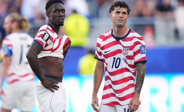 United States' Folarin Balogun (20) and United States' Christian Pulisic (10) stand by after Balogun received a red card during the World Cup round of 32 soccer match between the United States and Bosnia in Santa Clara, Calif., near San Francisco, Wednesday, July 1, 2026. (AP Photo/Martin Meissner)