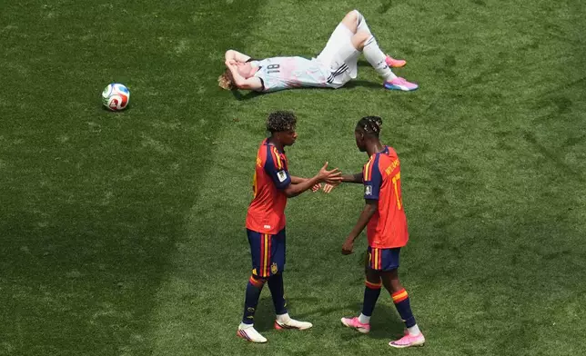 Spain's Lamine Yamal (19) and Nico Williams (17) celebrate in front of Belgium's Joaquin Seys (18) after the World Cup quarterfinal soccer match between Spain and Belgium in Inglewood, Calif., near Los Angeles, Friday, July 10, 2026. (AP Photo/Marcio J. Sanchez)