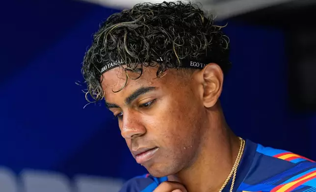 Spain's Lamine Yamal, wearing a headband that says 'Ego Yamal', comes out for warm up ahead of the World Cup quarterfinal soccer match between Spain and Belgium in Inglewood, Calif., near Los Angeles, Friday, July 10, 2026. (AP Photo/Gregory Bull)