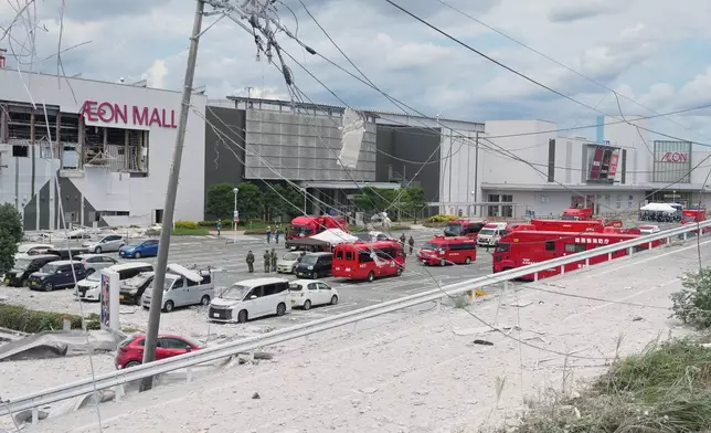 Emergency vehicles are seen in front of AEON Mall, which was damaged by an explosion following an earthquake, in Kashima, Kumamoto Prefecture, southern Japan, Wednesday, July 29, 2026. (AP Photo/Hiro Komae)