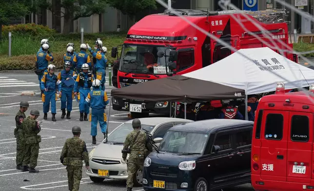 Firefighters and Self Defense Force members prepare their work at AEON Mall, which was damaged by an explosion following an earthquake, is seen in Kashima, Kumamoto Prefecture, southern Japan, Wednesday, July 29, 2026. (AP Photo/Hiro Komae)
