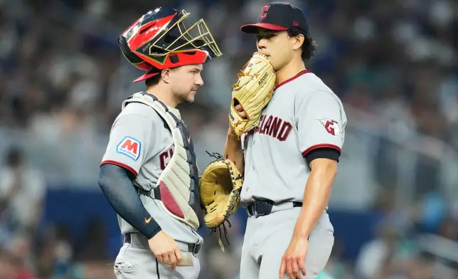 Cleveland Guardians catcher Patrick Bailey, left, talk with starting pitcher Joey Cantillo, right, during the third inning of a baseball game against the Miami Marlins, Sunday, July 12, 2026, in Miami. (AP Photo/Lynne Sladky)