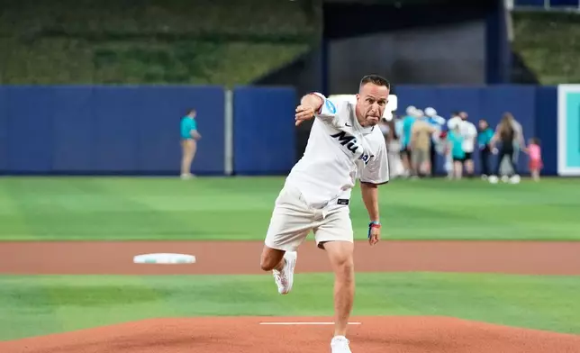 Miami Dolphins head coach Jeff Hafley tosses a baseball in the dugout before throwing a ceremonial pitch at a baseball game between the Miami Marlins and the Cleveland Guardians, Sunday, July 12, 2026, in Miami. (AP Photo/Lynne Sladky)