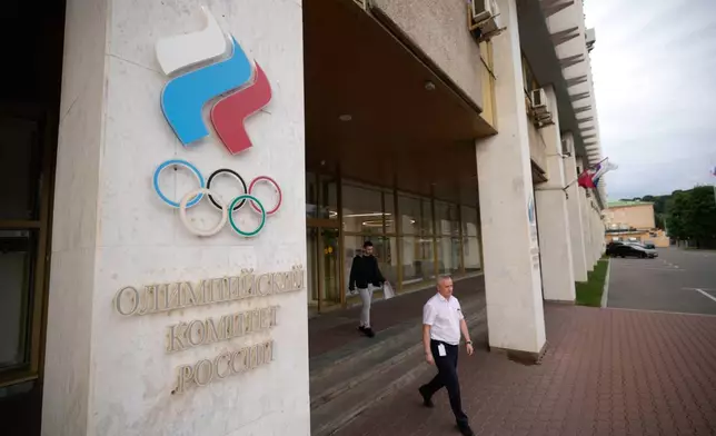 A man walks from the Russian National Olympic Committee building in Moscow, on Tuesday, July 7, 2026. (AP Photo/Pavel Bednyakov)