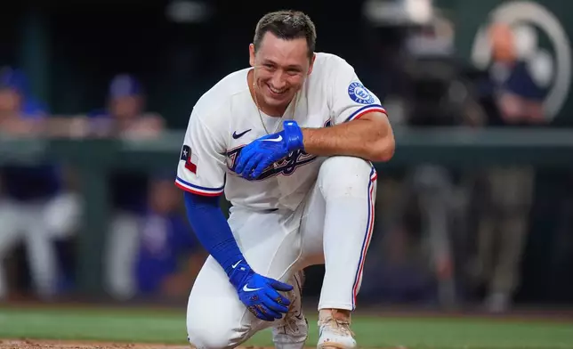 Texas Rangers' Wyatt Langford smiles after falling down during an at bat during the second inning of a baseball game against the Seattle Mariners, Saturday, July 25, 2026, in Arlington, Texas. (AP Photo/LM Otero)