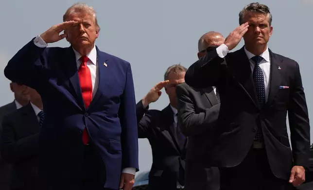 President Donald Trump and Defense Secretary Pete Hegseth salute as a U.S. Army carry team moves a transfer case containing the remains of Pvt. Isabella Gonzales of Carrollton, Texas, Wednesday, July 22, 2026, at Dover Air Force Base, Del. (AP Photo/Julia Demaree Nikhinson)