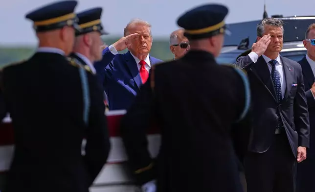 President Donald Trump and Secretary of Defense Pete Hegseth salute as a U.S. Army carry team moves a transfer case containing the remains of Sgt. Angel S. Rampersad, of Ozone Park, N.Y. Wednesday, July 22, 2026, at Dover Air Force Base, Del. (AP Photo/Matt Rourke)