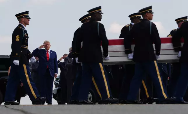 President Donald Trump salutes as a U.S. Army carry team moves a transfer case containing the remains of Staff Sgt. Michael Emmanuel Swinton of Fayetteville, N.C., Wednesday, July 22, 2026, at Dover Air Force Base, Del. (AP Photo/Julia Demaree Nikhinson)