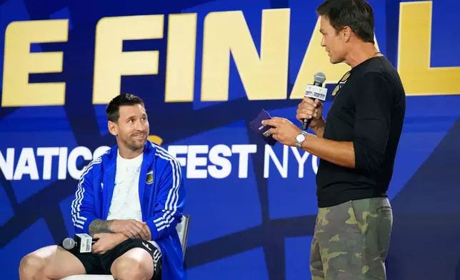 Argentina's Lionel Messi listens to former NFL player Tom Brady during a news conference ahead of the World Cup final soccer match between Spain and Argentina in New York, Friday, July 17, 2026. (AP Photo/Frank Franklin II)