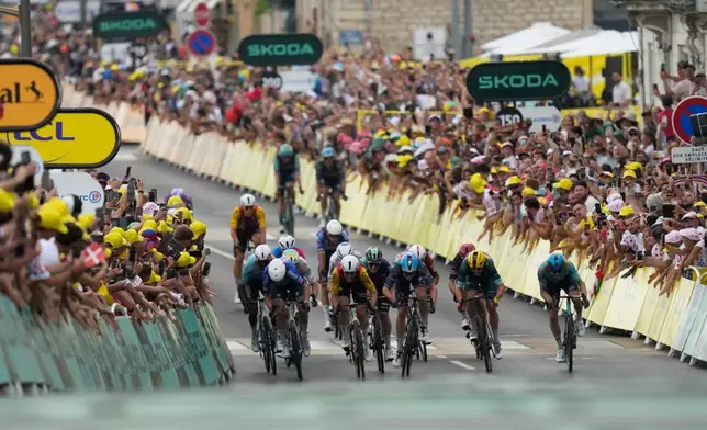 Riders sprint to the finish line of the twelfth stage of the Tour de France cycling race with start in Circuit Nevers Magny-Cours and finish in Chalon-sur-Saone, France, Thursday, July 16, 2026. (AP Photo/Mosa'ab Elshamy)