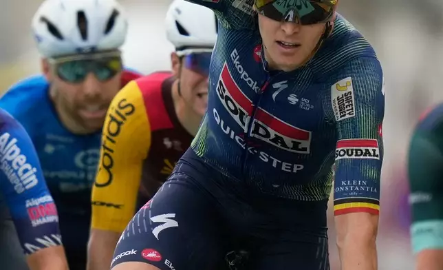 Belgium's Tim Merlier celebrates as he crosses the finish line to win the twelfth stage of the Tour de France cycling race with start in Circuit Nevers Magny-Cours and finish in Chalon-sur-Saone, France, Thursday, July 16, 2026. (AP Photo/Mosa'ab Elshamy)