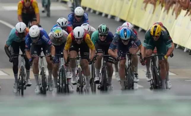 Riders sprint to the finish line of the twelfth stage of the Tour de France cycling race with start in Circuit Nevers Magny-Cours and finish in Chalon-sur-Saone, France, Thursday, July 16, 2026. (AP Photo/Mosa'ab Elshamy)