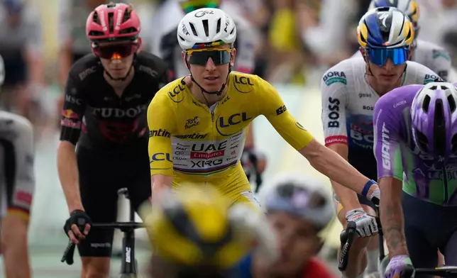 Slovenia's Tadej Pogacar, wearing the overall leader's yellow jersey crosses the finish line of the twelfth stage of the Tour de France cycling race with start in Circuit Nevers Magny-Cours and finish in Chalon-sur-Saone, France, Thursday, July 16, 2026. (AP Photo/Mosa'ab Elshamy)