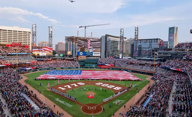 A Lockheed C-130H performs a flyover during Independence Day activities before a baseball game between the Atlanta Braves and the New York Mets, Saturday, July 4, 2026, in Atlanta. (AP Photo/Erik S. Lesser)