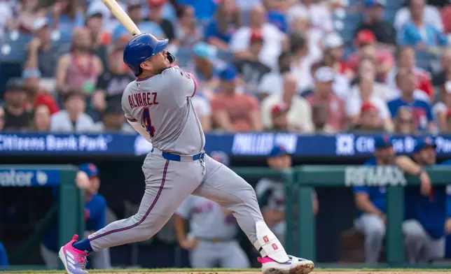 New York Mets' Francisco Alvarez hits a solo home run during the third inning of a baseball game against the Philadelphia Phillies, Thursday, July 16, 2026, in Philadelphia. (AP Photo/Chris Szagola)