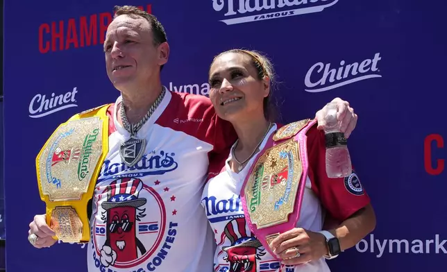 Joey Chestnut and Miki Sudo, winners of the 2026 Nathan's Famous Fourth of July hot dog eating contest, hold their title belts at Coney Island in the Brooklyn borough of New York, Saturday, July 4, 2026. (AP Photo/Anna Connors)