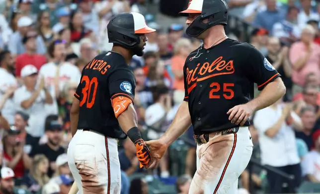 Baltimore Orioles' Pete Alonso celebrates with Baltimore Orioles' Leody Taveras after scoring a run during the third inning of a baseball game against the Atlanta Braves, Saturday, July 25, 2026, in Baltimore. (AP Photo/Daniel Kucin Jr.)