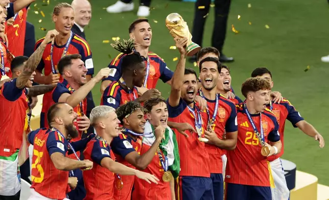 Spain's Rodri celebrates with the trophy after the World Cup final soccer match between Spain and Argentina in East Rutherford, N.J., near New York, Sunday, July 19, 2026. (AP Photo/Adam Hunger)